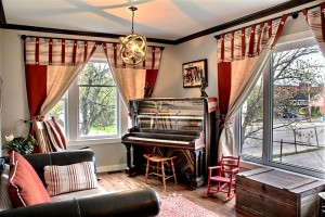 Main floor living room with 1903 piano