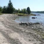 Farr Island beach on west side of the island. This is a unique feature for lake Temiskaming as the rough waters often prevent the formation of a beach. The beach is located on the west side and it does not get affected by the strong north-east winds. / LA plage de l'île Farr sur le côté ouest. La présence d'une plage est assez rare sur le lac Témiskaming à cause des fort vents.